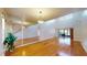 Bright living room with hardwood floors, high ceilings, and large mirror feature wall at 10488 Saint Tropez Pl, Tampa, FL 33615