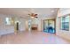 Open-concept living room with a fireplace, tiled floor, and sliding doors to the patio at 10488 Saint Tropez Pl, Tampa, FL 33615