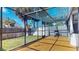 Spacious screened in patio with wood decking and views of the fenced backyard at 10488 Saint Tropez Pl, Tampa, FL 33615