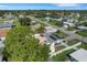 An aerial view of a home featuring solar panels, a driveway, and a lush green lawn at 1054 W Baffin Dr, Venice, FL 34293