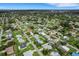 Aerial view of a peaceful neighborhood showcasing the property's location among lush greenery and well-maintained homes at 1054 W Baffin Dr, Venice, FL 34293