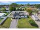Overhead view of the white home with solar panels, surrounded by a white fence and lush landscaping at 1054 W Baffin Dr, Venice, FL 34293