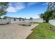 Backyard pool area with a brick patio, lawn, white privacy fence, and a utility shed at 1054 W Baffin Dr, Venice, FL 34293