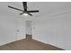 Bedroom featuring a ceiling fan, closet space, and a door leading to other areas of the house at 1054 W Baffin Dr, Venice, FL 34293