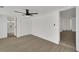 Large primary bedroom, ceiling fan, and modern gray wood-look flooring at 1054 W Baffin Dr, Venice, FL 34293