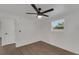 Clean bedroom featuring wood-look vinyl floors, a modern ceiling fan, a window, and white doors and trim at 1054 W Baffin Dr, Venice, FL 34293