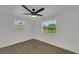 Clean, bright bedroom featuring vinyl wood floors, a modern ceiling fan, and white walls at 1054 W Baffin Dr, Venice, FL 34293