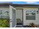 Open front door welcomes you to the home's bright interior with hardwood floors at 1054 W Baffin Dr, Venice, FL 34293