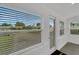 Bright, sunny living area with large windows showcasing the lush landscape at 1054 W Baffin Dr, Venice, FL 34293