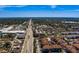 Expansive aerial view showcasing the neighborhood, amenities, and surrounding landscape with a clear blue sky at 1216 S Missouri Ave # 225, Clearwater, FL 33756