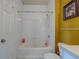 Clean bathroom featuring a tub with shower, tiled walls, and a neutral color scheme at 1216 S Missouri Ave # 225, Clearwater, FL 33756