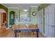 Dining area with an open view to the kitchen, wood floors, light green walls, and white trim at 1216 S Missouri Ave # 225, Clearwater, FL 33756