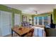 Living and dining area featuring wood floors, a dining table, a couch, and a window with plantation shutters at 1216 S Missouri Ave # 225, Clearwater, FL 33756