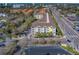 Exterior view of a condo building with palm trees, a parking lot and a view of the surrounding neighborhood at 1216 S Missouri Ave # 225, Clearwater, FL 33756