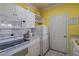 Functional kitchen with white appliances, including a microwave and range, next to convenient storage at 1216 S Missouri Ave # 225, Clearwater, FL 33756