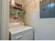 Practical laundry area with a washing machine, shelving, and adjacent electrical panel for utility access at 1216 S Missouri Ave # 225, Clearwater, FL 33756