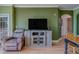 Cozy living room with hardwood floors, a TV, an archway, and comfortable seating with a dining table nearby at 1216 S Missouri Ave # 225, Clearwater, FL 33756