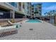 Inviting community pool with lounge chairs, perfect for relaxation and enjoying the sunny outdoor environment at 1216 S Missouri Ave # 225, Clearwater, FL 33756