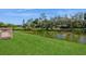 Lush backyard with pond views, perfect for outdoor activities at 1400 Water View W Dr # 102, Largo, FL 33771