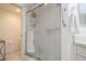 Bathroom featuring a glass shower, white tile, and updated fixtures at 1400 Water View W Dr # 102, Largo, FL 33771