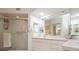 Bright bathroom with a glass-enclosed shower, double vanity, and plenty of counter space at 1400 Water View W Dr # 102, Largo, FL 33771
