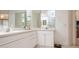 Bathroom features a dual vanity with white cabinets, a large mirror, and modern fixtures at 1400 Water View W Dr # 102, Largo, FL 33771