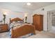 Well-lit bedroom showcasing a rattan bed frame and matching furniture at 1400 Water View W Dr # 102, Largo, FL 33771