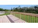 Large wooden deck overlooking a tranquil pond and lush greenery, great for outdoor entertainment at 1400 Water View W Dr # 102, Largo, FL 33771