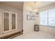 Bright dining area with modern lighting and adjacent patio doors at 1400 Water View W Dr # 102, Largo, FL 33771