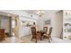 Cozy dining area showcases a round table and chairs, with a view into the kitchen at 1400 Water View W Dr # 102, Largo, FL 33771
