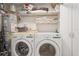 Well-equipped laundry room with washer, dryer, and storage at 1400 Water View W Dr # 102, Largo, FL 33771