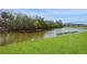 Community pond with lush green lawn and trees for a peaceful surrounding at 1400 Water View W Dr # 102, Largo, FL 33771
