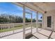 Relaxing screened porch offers panoramic views of the lake and trees, perfect for enjoying the outdoors at 1400 Water View W Dr # 102, Largo, FL 33771