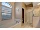 Bright bathroom with a soaking tub, tile floors and shower stall at 1453 Appleton Pl, Wesley Chapel, FL 33543
