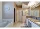 Bathroom featuring a soaking tub, walk-in shower, and dual sink vanity at 1453 Appleton Pl, Wesley Chapel, FL 33543
