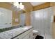 Nicely lit bathroom featuring granite countertop, large mirror, shower and white tiled floors at 1453 Appleton Pl, Wesley Chapel, FL 33543