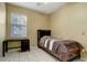 Bright bedroom featuring tile flooring, a ceiling fan, a modern desk and a bed with patterned bedding at 1453 Appleton Pl, Wesley Chapel, FL 33543