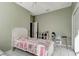 Comfortable bedroom with soft green walls, tile flooring, a ceiling fan, and desk area with seating at 1453 Appleton Pl, Wesley Chapel, FL 33543