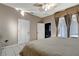 Light and airy bedroom with neutral walls, tile flooring, a ceiling fan, and a king bed with access to the patio at 1453 Appleton Pl, Wesley Chapel, FL 33543