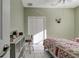 Cozy bedroom with soft green walls, tile floors, a ceiling fan, and a large closet with decorative wall hangings at 1453 Appleton Pl, Wesley Chapel, FL 33543