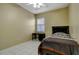 Well-lit bedroom featuring tile flooring, a ceiling fan, a black desk and a black bed with striped bedding at 1453 Appleton Pl, Wesley Chapel, FL 33543