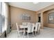 Elegant dining area with a modern table set, tiled floors, and stylish decor at 1453 Appleton Pl, Wesley Chapel, FL 33543