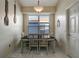 Charming dining area with a dark wood table, seating for four, and bright natural light at 1453 Appleton Pl, Wesley Chapel, FL 33543