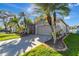 Attractive home with manicured lawn, mature palm trees, and a spacious driveway at 1453 Appleton Pl, Wesley Chapel, FL 33543