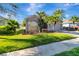 Well-maintained home featuring a green lawn, mature landscaping, and an inviting facade at 1453 Appleton Pl, Wesley Chapel, FL 33543