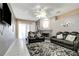 Spacious living room featuring dark leather couches and a fireplace at 1453 Appleton Pl, Wesley Chapel, FL 33543