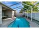View of the screened-in pool and patio area from the backyard at 1453 Appleton Pl, Wesley Chapel, FL 33543