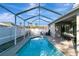 View of the pool and patio area surrounded by a screened-in enclosure at 1453 Appleton Pl, Wesley Chapel, FL 33543