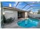 View of the screened-in pool and patio area from the backyard at 1453 Appleton Pl, Wesley Chapel, FL 33543