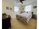 Comfortable bedroom with natural light, ceiling fan, and floral bedding for a cozy atmosphere at 1620 Dander Dr, Holiday, FL 34690